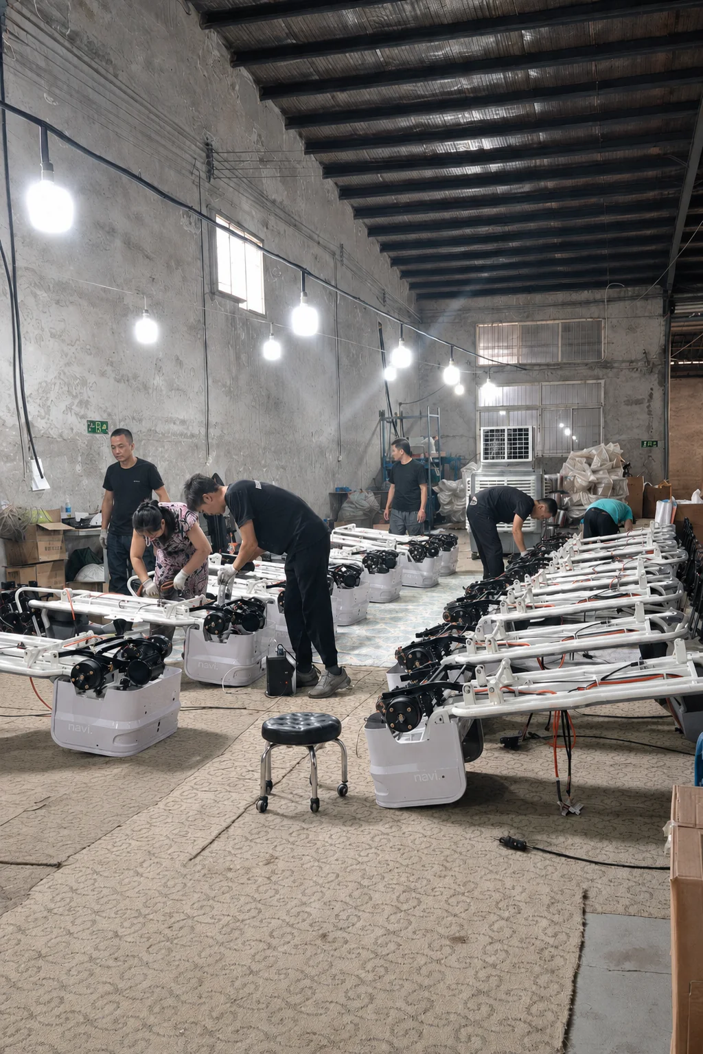 NAVERO workers assembling electric tricycles and electrical systems