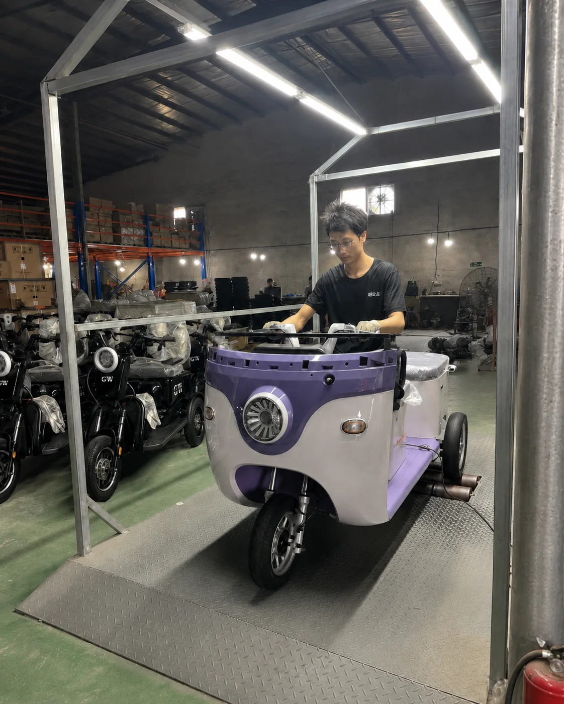 Electric tricycle undergoing functional inspection at a testing station